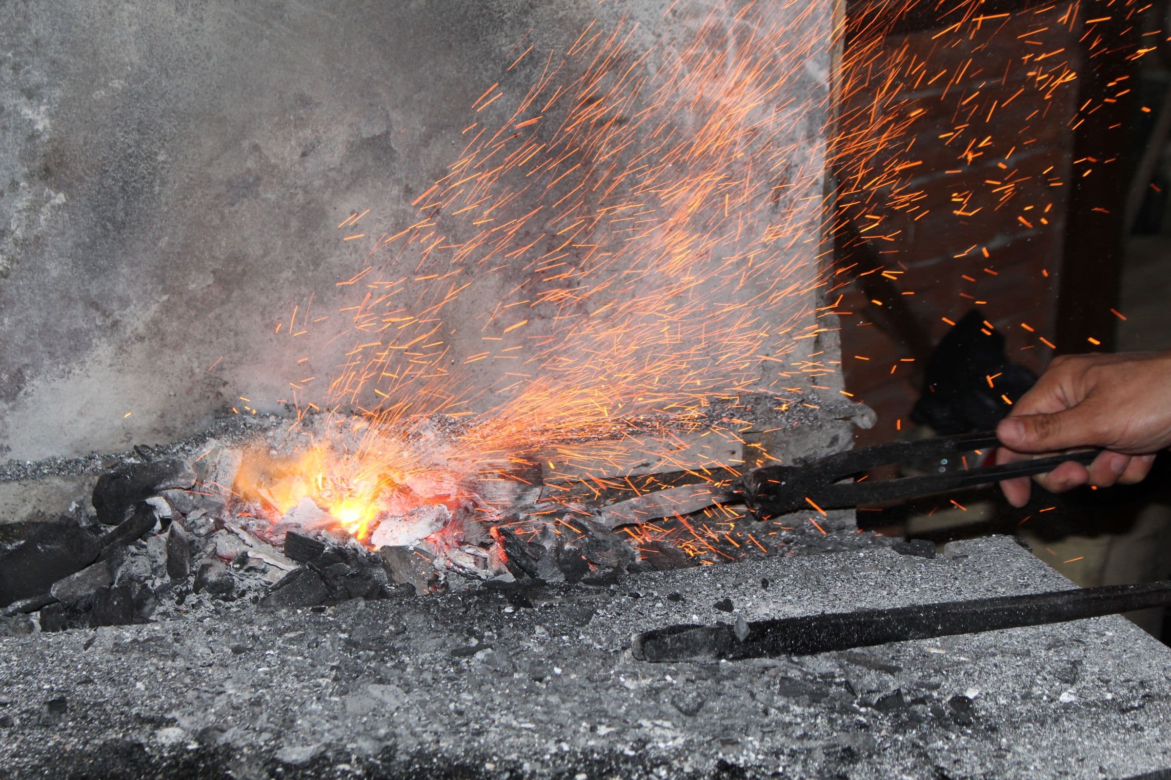 Sparks flying from a blacksmith's forge