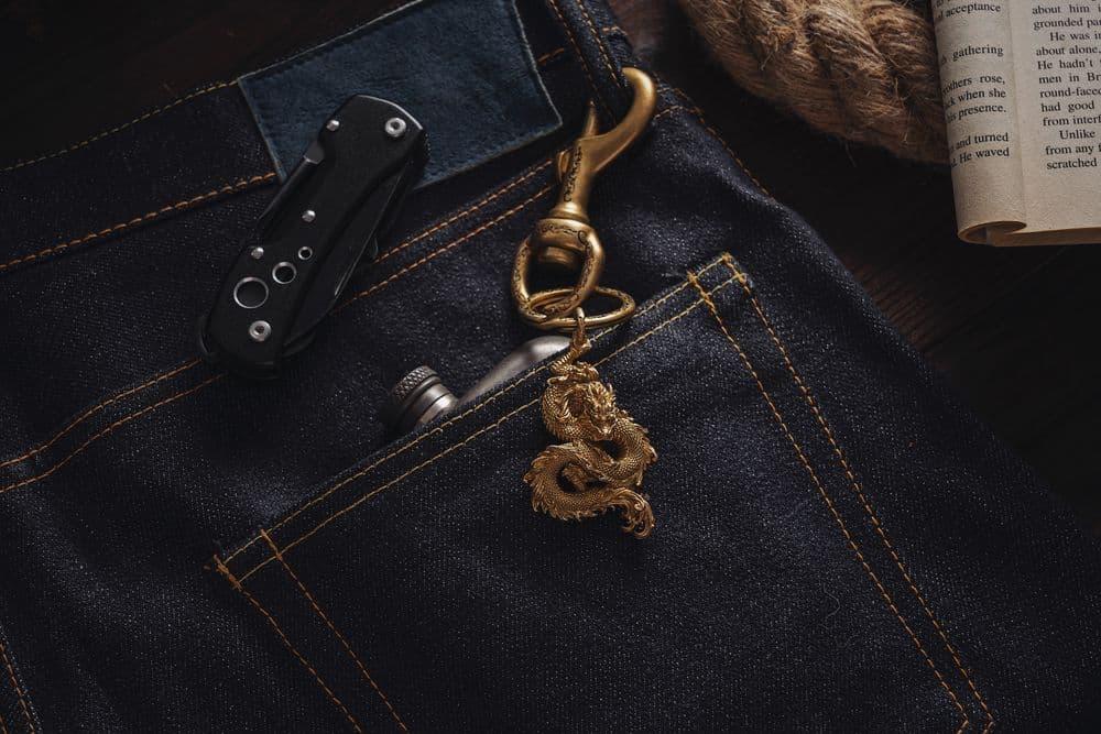 Folding knife handle peeking out of a denim pocket